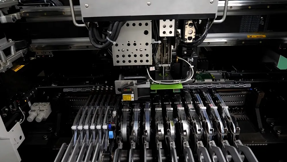 Automated SMT pick and place PCB assembly machine in action